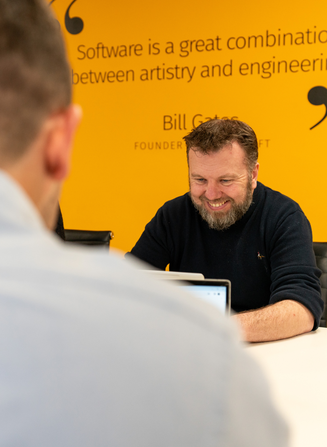 Man smiling looking at laptop