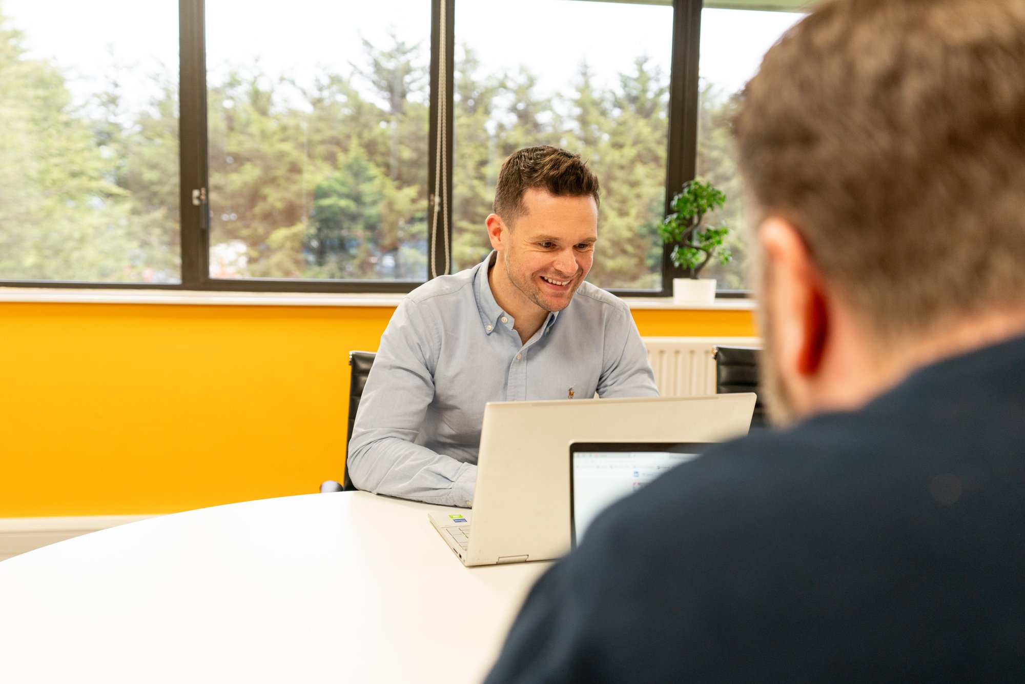 Man sat at table with laptop