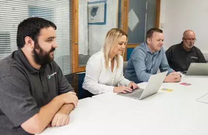 IT-Project-Consultancy-Four-People-in-Meeting-Room-Using-Laptop-430x280