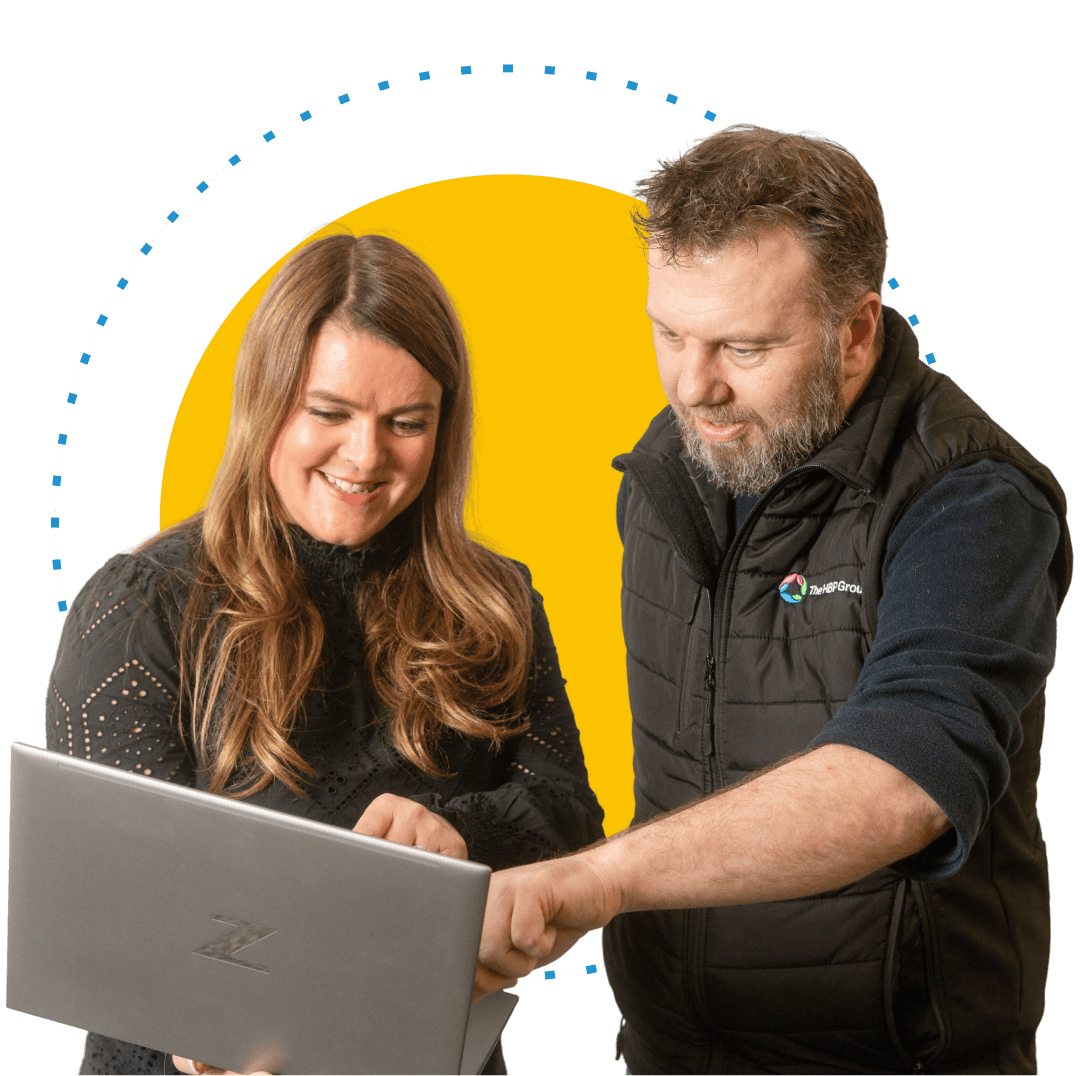Joanne showing man something on laptop